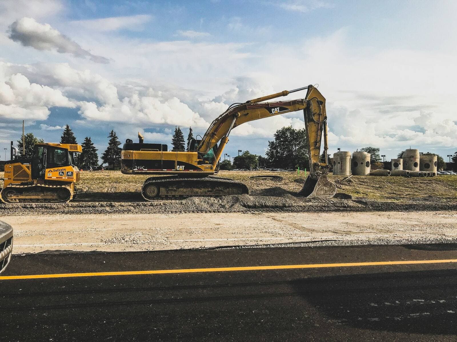 Excavator working a graded foundation pad